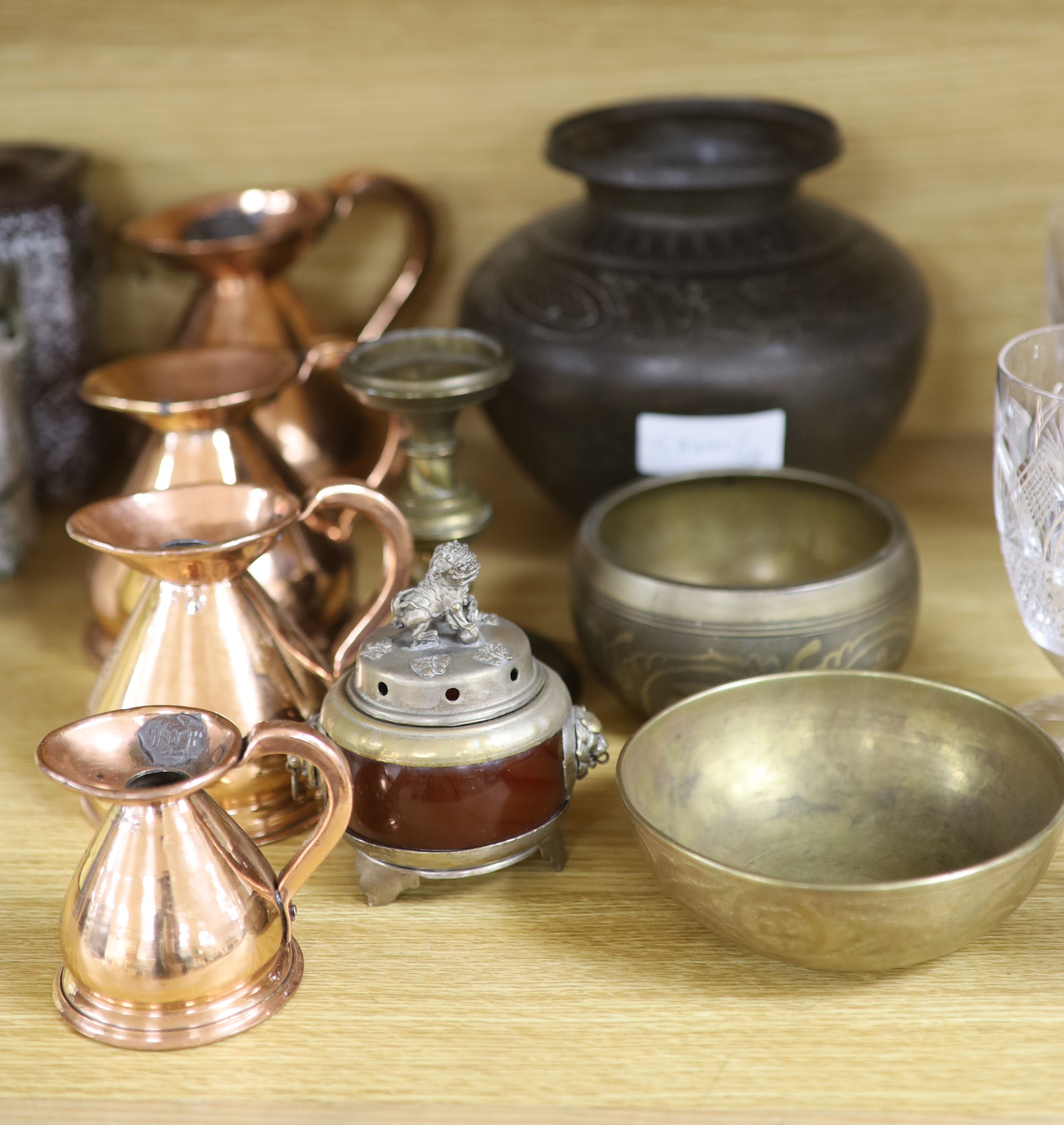 Four copper graduated measures and mixed metalware including Eastern brass